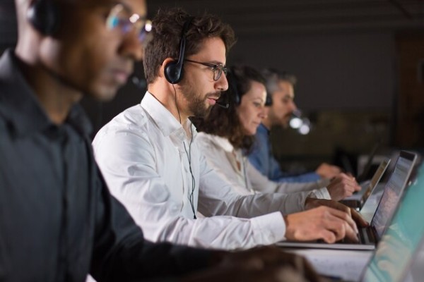 A Woman with a Headset Works on a Laptop, Providing Online Customer Support with Icons Indicating 24/7 Availability, Technical Assistance, and Phone Communication